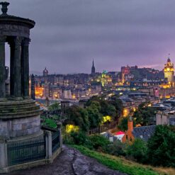 Iconic view of Edinburgh from Calton Hill at sunset, featuring the Dugald Stewart Monument