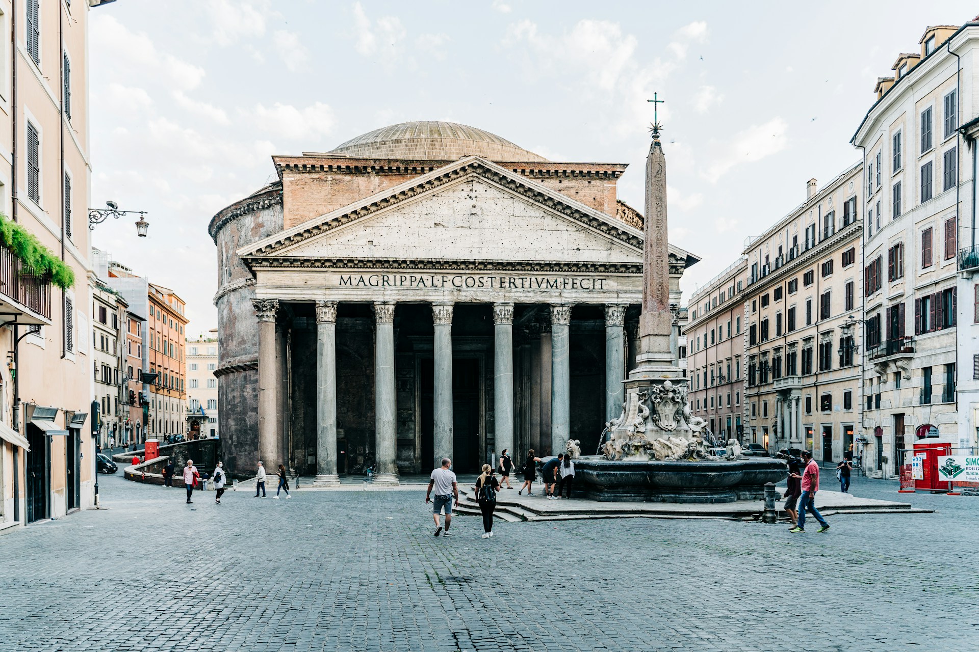 The Pantheon in Rome with its grand columns, Latin inscription, and an obelisk fountain in Piazza della Rotonda.
