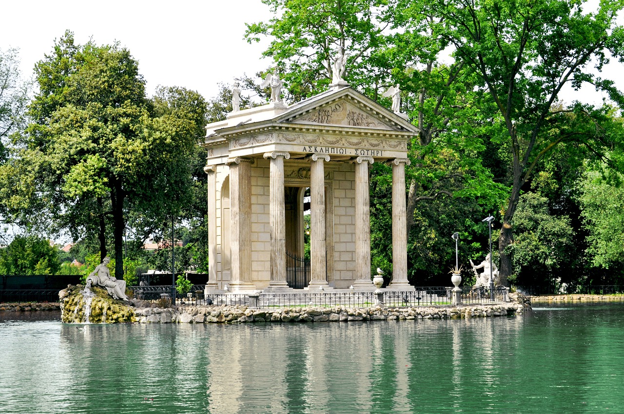 Temple of Aesculapius in Villa Borghese and Galleria Borghese, Rome, surrounded by a scenic lake and lush greenery.